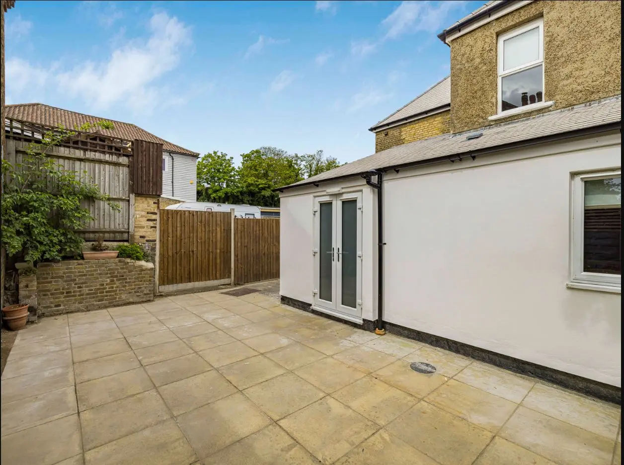 Paved rear patio and garden access at 2 Essex Road